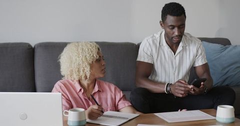 Friends Collaborating on Creative Project with Technology