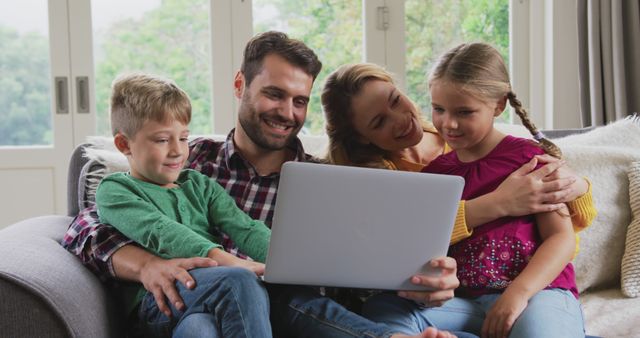 Happy Family Using Laptop Together on Sofa - Download Free Stock Images Pikwizard.com