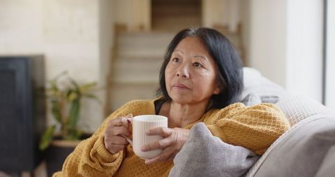 Senior woman relaxing with coffee in cozy home environment