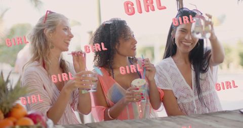 Three Diverse Female Friends Celebrating at Sunny Bar with Cocktails