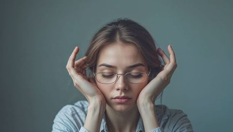 Introspective woman in eyeglasses contemplating
