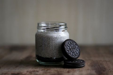 Cookies and cream dessert in glass jar with chocolate cookies