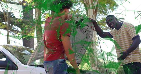 Two men inspecting car engine on sunlit roadside under trees, casual roadside repair