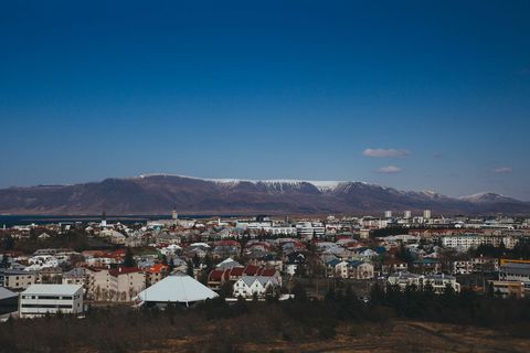 Reykjavik skyline with snow-capped esja mountains under clear deep blue sky urban coastal panorama
