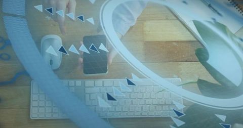 Hands holding smartphone and tapping over keyboard on wooden desk with lamp, plant and digital overl
