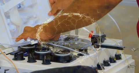 Technician adjusting medical tubing with data overlay in laboratory
