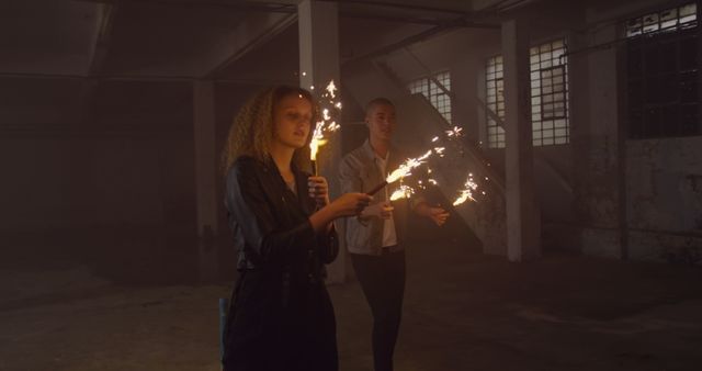 Friends Holding Sparklers in Dark Industrial Space Celebrating - Download Free Stock Images Pikwizard.com