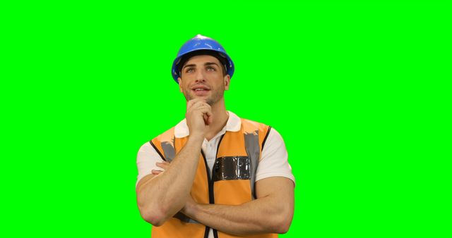 Thoughtful Construction Worker in Safety Gear on Green Background - Download Free Stock Images Pikwizard.com