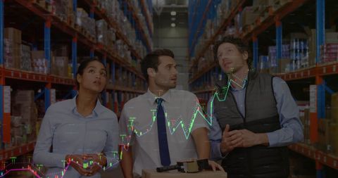 Team of warehouse analysts with overlayed financial graphs