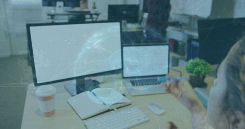 Pointing woman working with dual monitors and holographic AI overlay on office desk
