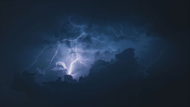 Intense Lightning Bolt Illuminating Night Storm Clouds