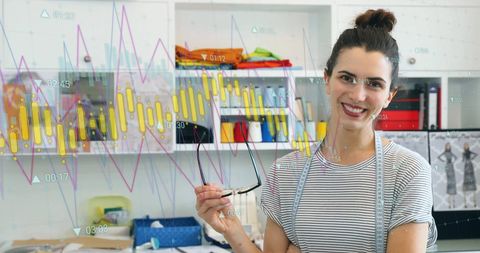 Fashion Designer with Data Graphs in Creative Studio