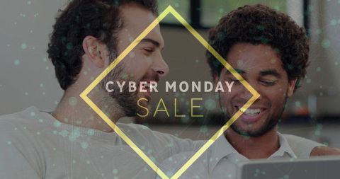 Two men smiling while shopping online for cyber monday deals