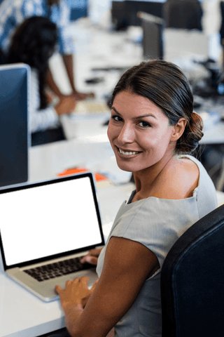 Portrait of Smiling Businesswoman with Laptop in Transparent Office Setting