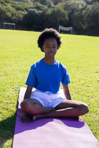 Teen practicing mindful meditation outdoors in serenity