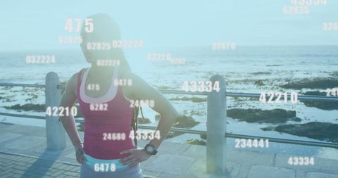 Confident Athlete on Coastal Run Analyzing Performance Data