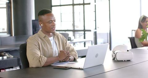 Confident Professional Engaging in Virtual Meeting at Modern Office