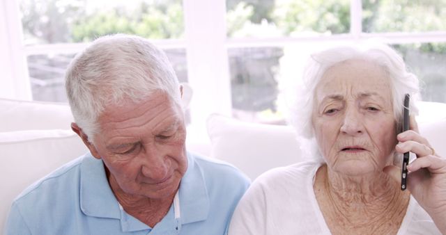 Elderly Couple Communicating via Phone at Home - Download Free Stock Images Pikwizard.com