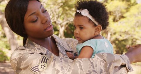 Military Mother Embracing Daughter in Beautiful Family Moment