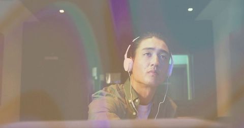 Focused Man Wearing Headphones in Creative Studio Environment