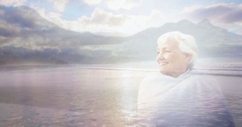 Happy Senior Woman Radiating Joy over Tranquil Beach