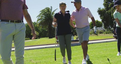 Senior Couple Enjoying a Day on the Golf Course in Sunny Weather
