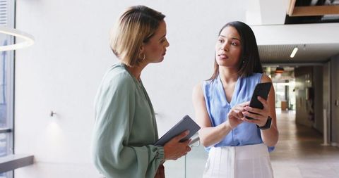 Businesswomen Collaborating with Technology in Modern Office - Download Free Stock Images Pikwizard.com