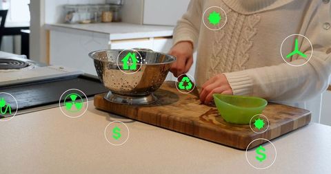 Woman preparing food on minimalist kitchen counter with eco icons and cutting board