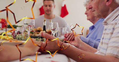 Joyous Family Praying Together at Christmas Dinner - Download Free Stock Images Pikwizard.com