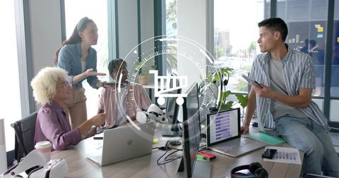 Collaborating diverse tech team planning product launch with laptops VR and analytics