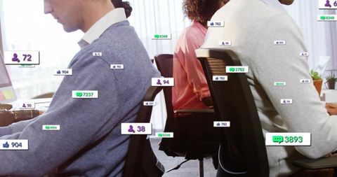 Colleagues working in open-plan office with floating social media metrics and analytics
