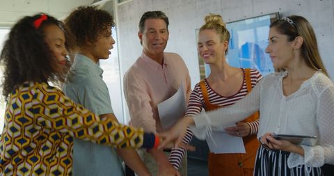 Diverse Work Team Collaborating with Handshake Unity Gesture