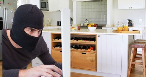 Hacker in Mask Typing on Computer in Modern Kitchen - Download Free Stock Images Pikwizard.com
