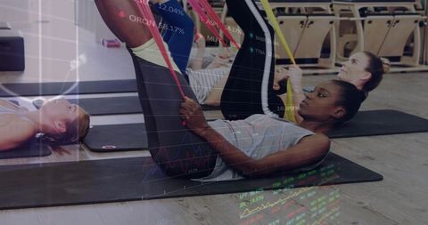 Group women stretching with resistance bands on mats, chart overlay showing fitness analytics