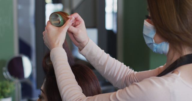 Hairdresser Styling Client Hair with Curlers at Salon - Download Free Stock Images Pikwizard.com