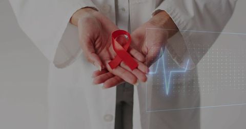 Doctor holding red ribbon for hiv aids awareness in cupped hands with ecg heartbeat