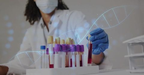 Lab technician handling blood tubes with dna helix overlay for genetics research