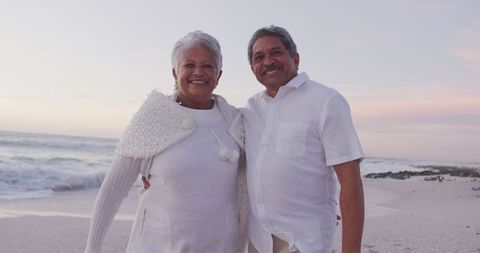 Happy senior couple enjoying beach sunset togetherness