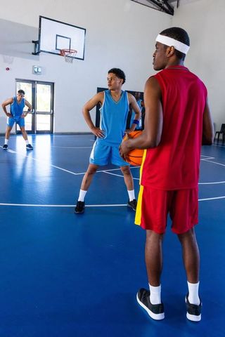 Teenage Basketball Players Training on Indoor Blue Court