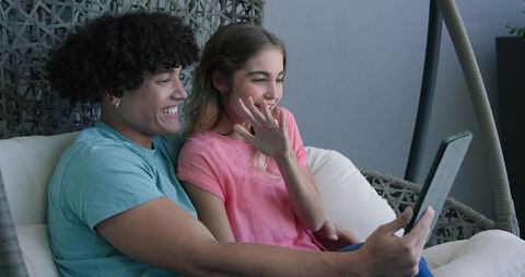 Couple Enjoying Video Call on Swing Chair