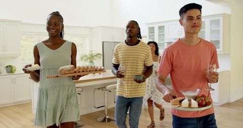 Diverse friends gathering for home celebration with snacks