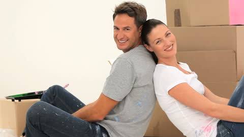 Happy Couple Taking a Break While Renovating Home