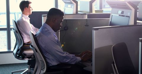 Diverse Professionals Working at Desks in Contemporary Office