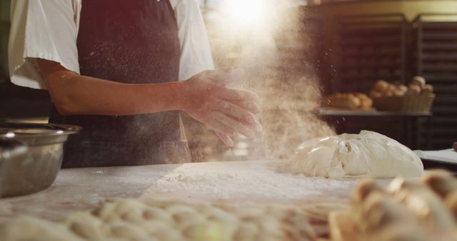 Image of midsection of biracial male baker clapping hands to clean flour at bakery - Download Free Stock Photos Pikwizard.com