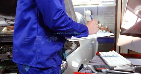 Auto technician recording diagnostic checklist on clipboard beside car with open hood