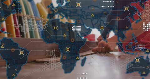 Leaning man pointing at documents with world map network overlay for business planning