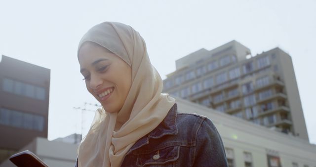 Smiling Muslim Woman Texting on Smartphone Outdoors - Download Free Stock Images Pikwizard.com