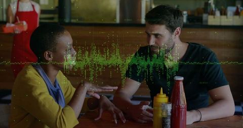 Two adults having animated diner conversation with audio waveform visualization overlay