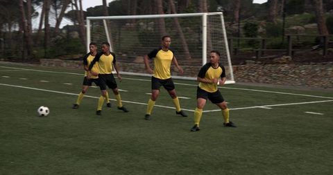 Soccer Players Competing for Ball on Field