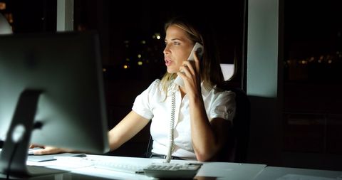 Late Night Office Work with Focused Conversation